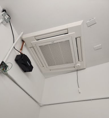 Technician installing a mini-split AC unit